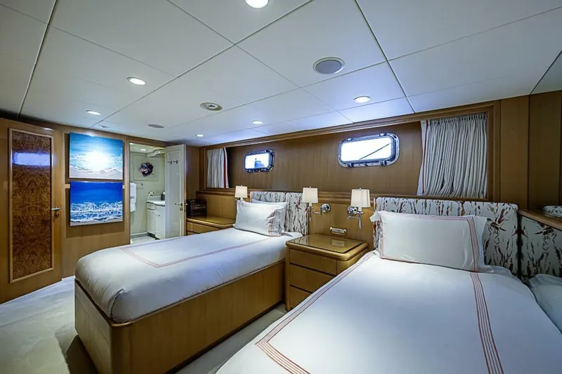 Probability Yacht Photos Pics Luxurious twin bedroom on 1997 Delta 122 Tri-Deck Motor Yacht, featuring elegant decor and ocean artwork.