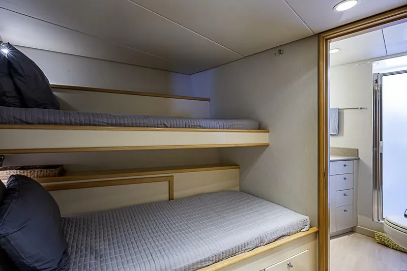 Probability Yacht Photos Pics Bunk beds in a 1997 Delta 122 Tri-Deck Motor Yacht cabin with adjacent bathroom.