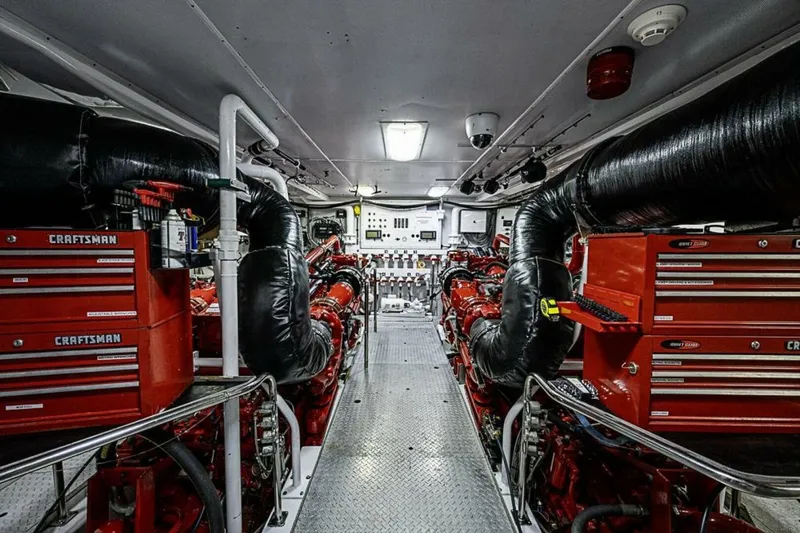 Probability Yacht Photos Pics Engine room of 1997 Delta 122 Tri-Deck Motor Yacht with red Craftsman toolboxes.