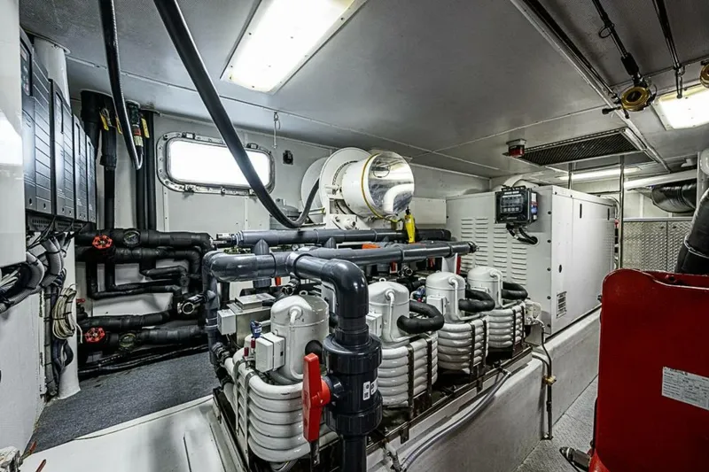 Probability Yacht Photos Pics Engine room of 1997 Delta 122 Tri-Deck Motor Yacht, showcasing complex machinery and piping.