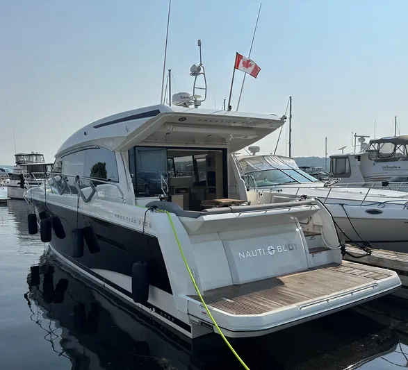  Yacht Photos Pics 2023 Prestige 520S yacht docked, featuring sleek design and Canadian flag.