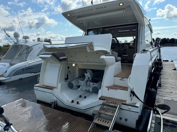  Yacht Photos Pics Luxury 2023 Prestige 520S yacht docked, showcasing open storage compartment and sleek design.