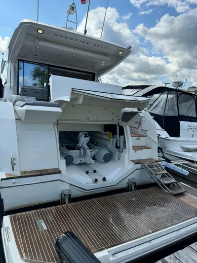  Yacht Photos Pics 2023 Prestige 520S yacht with open storage, docked under a cloudy sky.