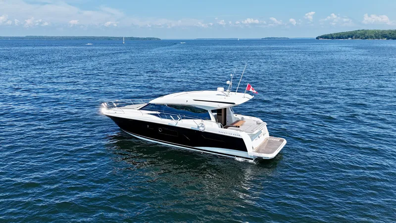  Yacht Photos Pics 2023 Prestige 520S yacht cruising on a serene blue ocean.