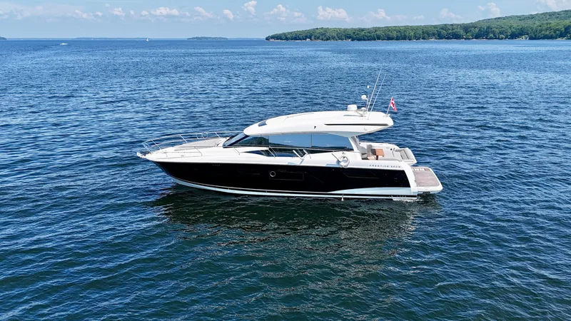  Yacht Photos Pics 2023 Prestige 520S yacht cruising on a serene blue lake.