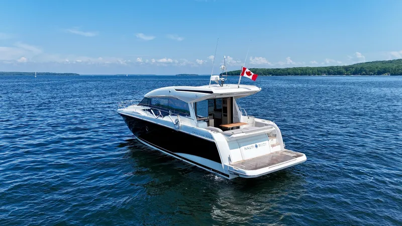  Yacht Photos Pics 2023 Prestige 520S yacht on open water with Canadian flag, clear blue sky.