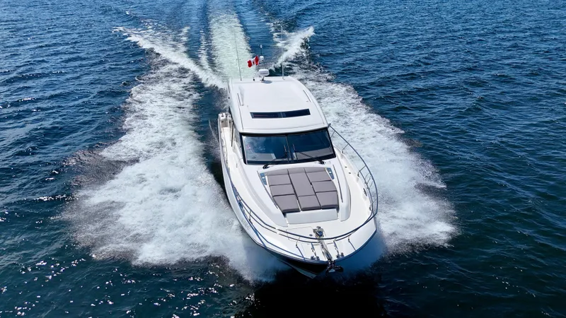  Yacht Photos Pics 2023 Prestige 520S yacht cruising on open water, aerial view.