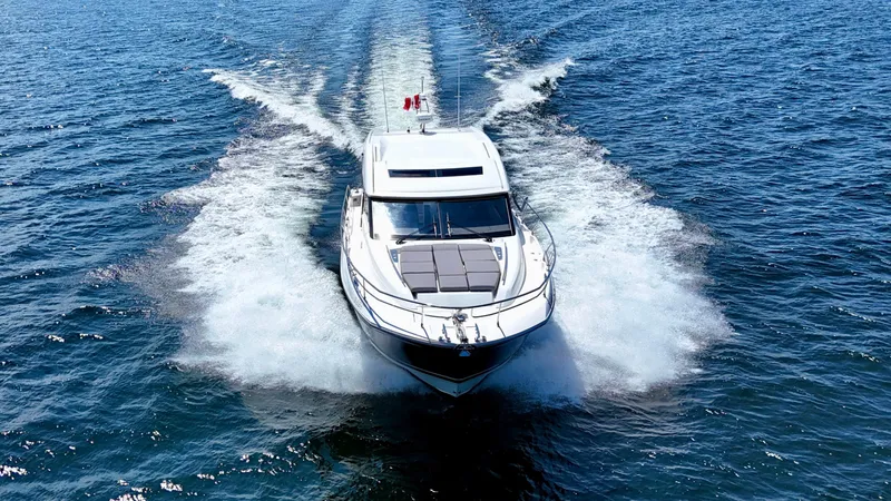  Yacht Photos Pics 2023 Prestige 520S yacht cruising on open water, leaving a wake behind.