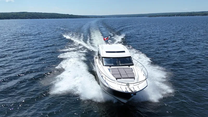  Yacht Photos Pics 2023 Prestige 520S yacht cruising on open water, leaving a wake behind.