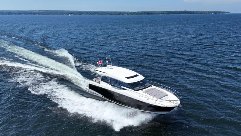  Yacht Photos Pics 2023 Prestige 520S yacht cruising on open water, leaving a wake behind.