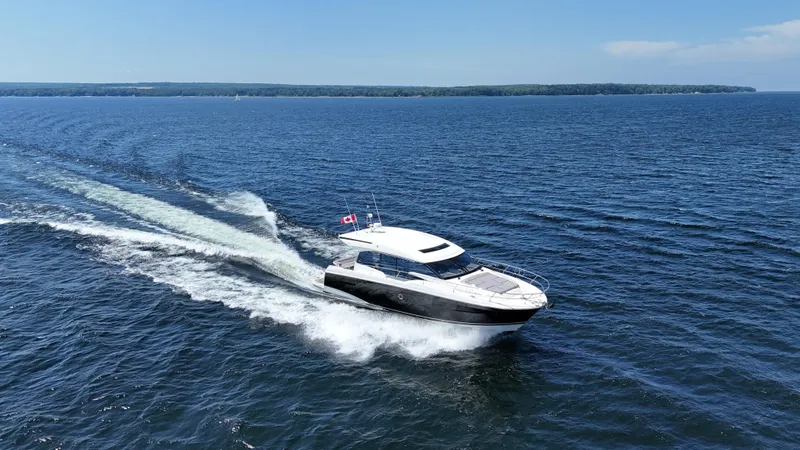  Yacht Photos Pics 2023 Prestige 520S yacht cruising on open water under clear skies.