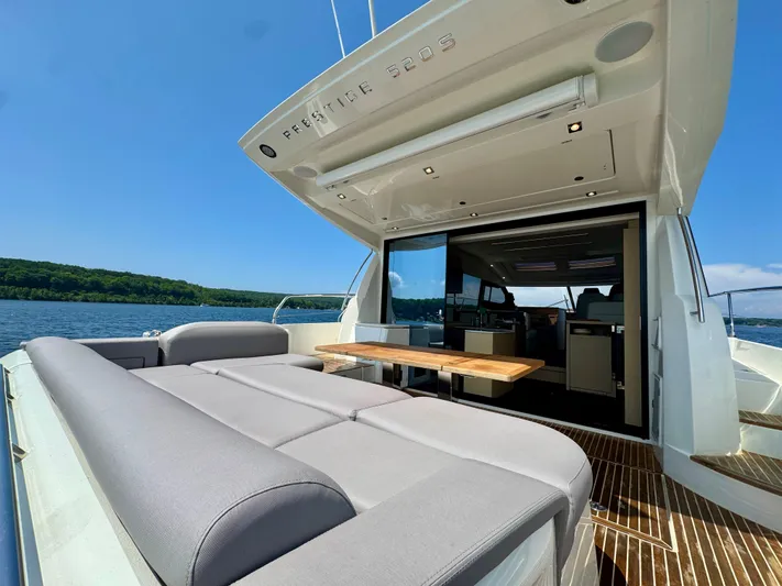  Yacht Photos Pics 2023 Prestige 520S yacht with spacious deck and luxurious seating on a sunny day.
