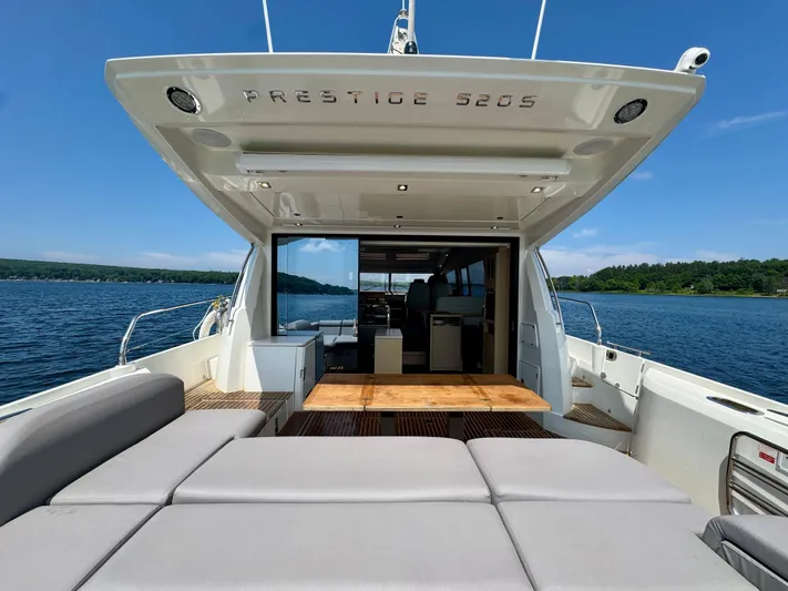  Yacht Photos Pics Luxury 2023 Prestige 520S yacht interior with open deck, scenic water view.