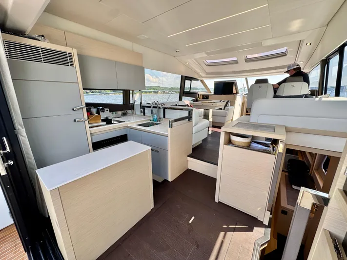  Yacht Photos Pics Luxurious interior of 2023 Prestige 520S yacht featuring modern kitchen and seating area.