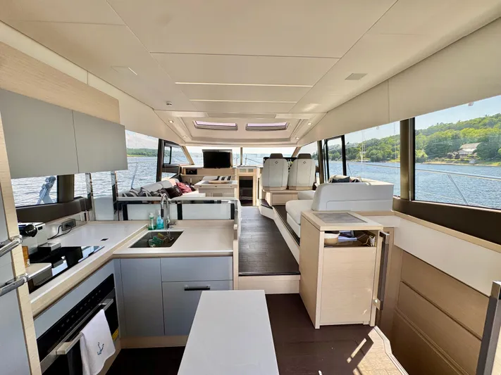  Yacht Photos Pics Luxurious interior of 2023 Prestige 520S yacht with modern kitchen and scenic water views.
