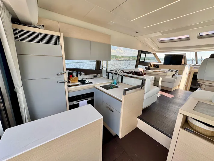 Yacht Photos Pics Luxurious interior of 2023 Prestige 520S yacht with modern kitchen and seating area.