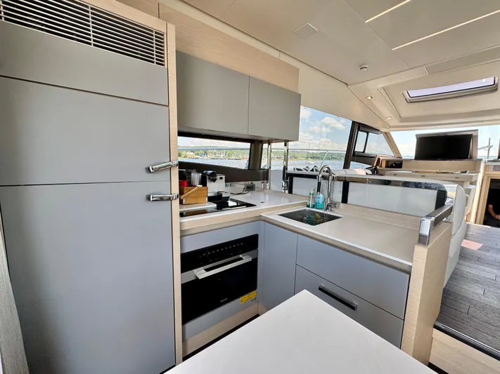  Yacht Photos Pics Modern kitchen interior on 2023 Prestige 520S yacht, featuring sleek cabinetry and appliances.