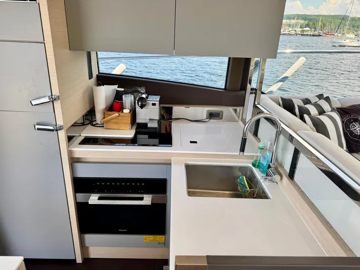  Yacht Photos Pics Modern kitchen interior on 2023 Prestige 520S yacht with sleek appliances and waterfront view.