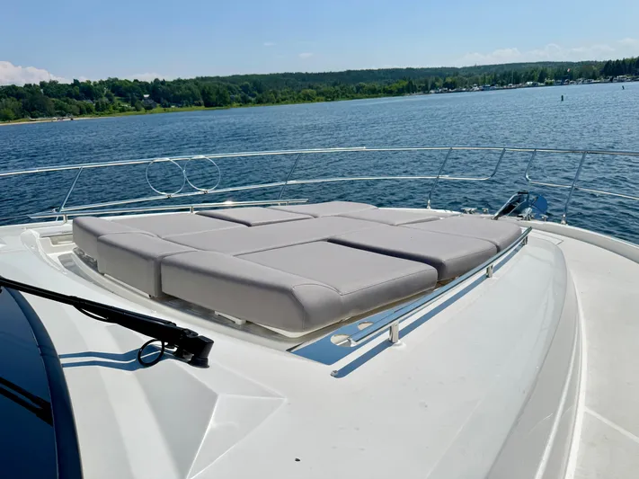  Yacht Photos Pics 2023 Prestige 520S yacht with sunbathing deck on calm water.