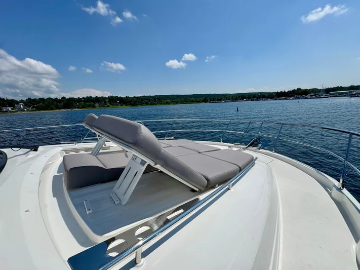  Yacht Photos Pics 2023 Prestige 520S yacht with sun loungers on deck, cruising on a sunny day.