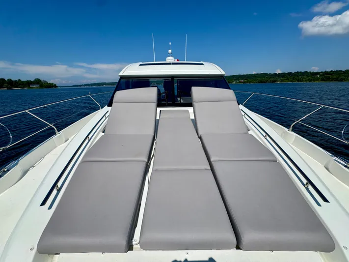  Yacht Photos Pics 2023 Prestige 520S yacht with sun loungers on deck, cruising on a serene lake.