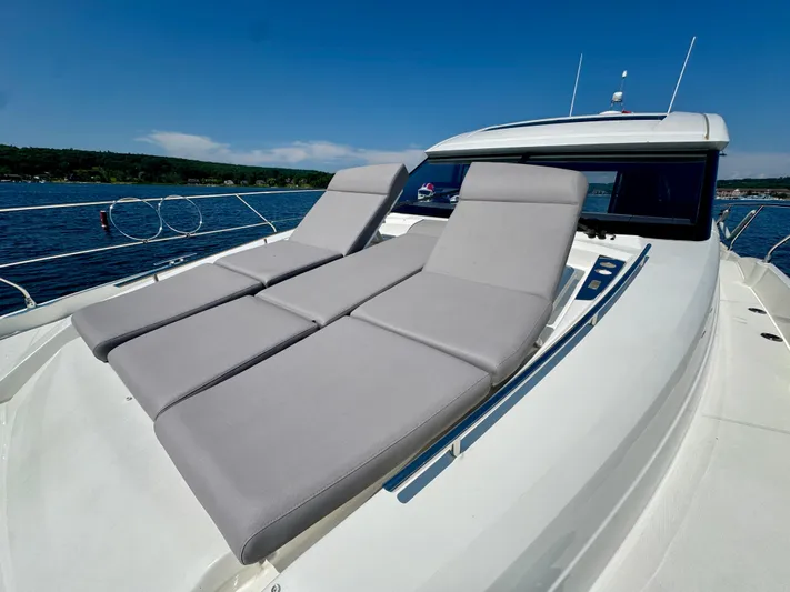  Yacht Photos Pics 2023 Prestige 520S yacht with sun loungers on deck, cruising on a sunny day.