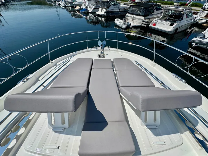  Yacht Photos Pics Luxury 2023 Prestige 520S yacht with sun loungers at marina.