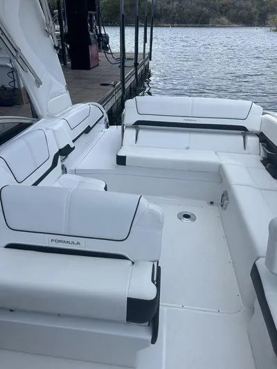  Yacht Photos Pics 2025 Formula 290 Bowrider boat interior with white seating by the water.