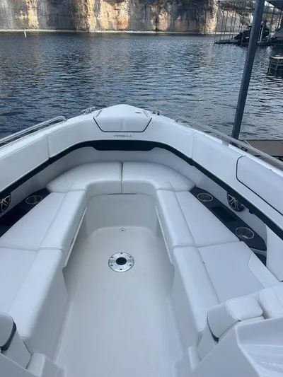  Yacht Photos Pics 2025 Formula 290 Bowrider boat with spacious seating, docked by a serene lake.