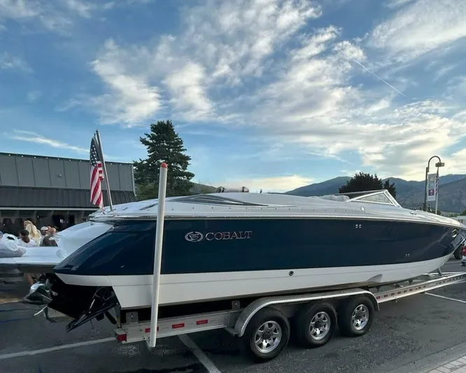  Yacht Photos Pics 2005 Cobalt 343 boat on trailer with American flag, parked outdoors.