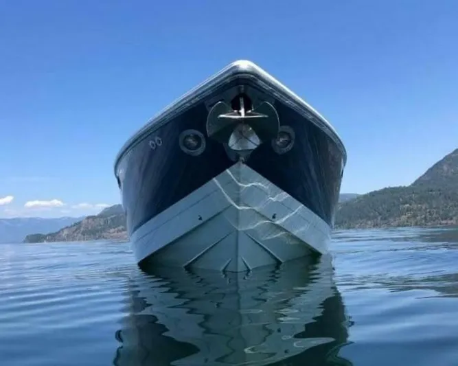  Yacht Photos Pics 2005 Cobalt 343 boat on calm water with scenic mountain backdrop.