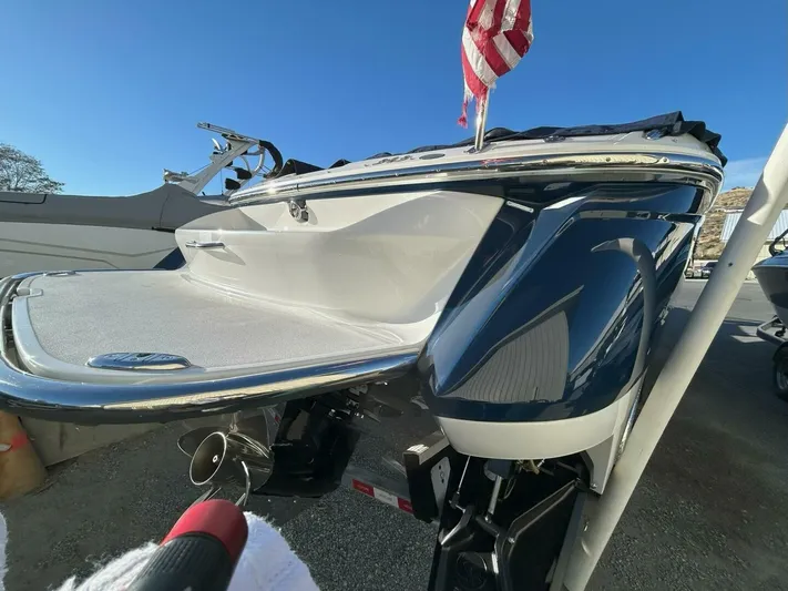  Yacht Photos Pics 2005 Cobalt 343 boat with American flag, docked under clear blue sky.