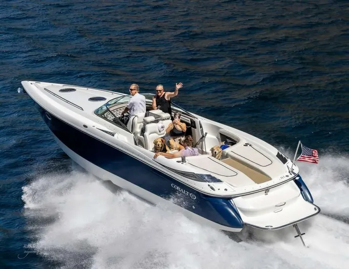  Yacht Photos Pics 2005 Cobalt 343 speedboat cruising with passengers and a dog on open water.