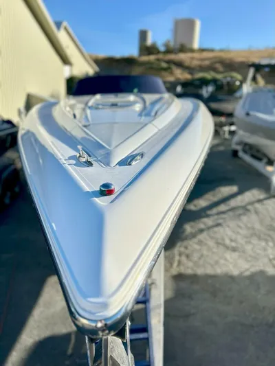  Yacht Photos Pics 2005 Cobalt 343 boat, sleek white hull, docked outdoors under clear blue sky.