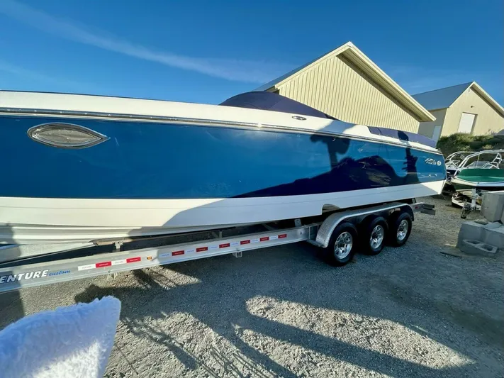  Yacht Photos Pics 2005 Cobalt 343 boat on trailer, blue and white exterior, parked outdoors.