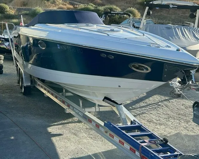  Yacht Photos Pics 2005 Cobalt 343 boat on trailer, parked outdoors, with a sleek blue and white design.