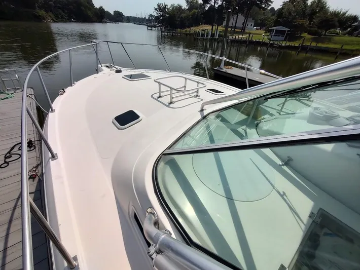 Reel Time Yacht Photos Pics 2005 Rampage 38 Express yacht docked by a serene river.