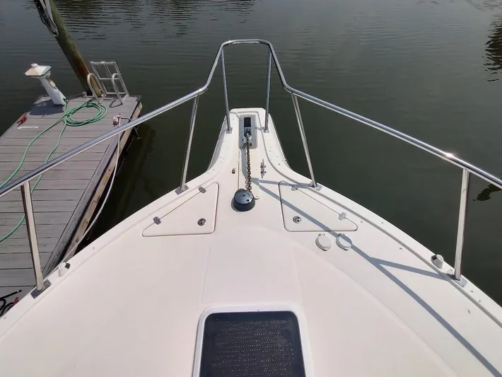 Reel Time Yacht Photos Pics Bow view of 2005 Rampage 38 Express boat docked by a pier.
