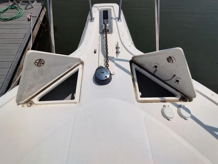Reel Time Yacht Photos Pics Bow of 2005 Rampage 38 Express boat with open anchor hatches and chain.