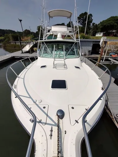 Reel Time Yacht Photos Pics 2005 Rampage 38 Express boat docked at marina, front view.