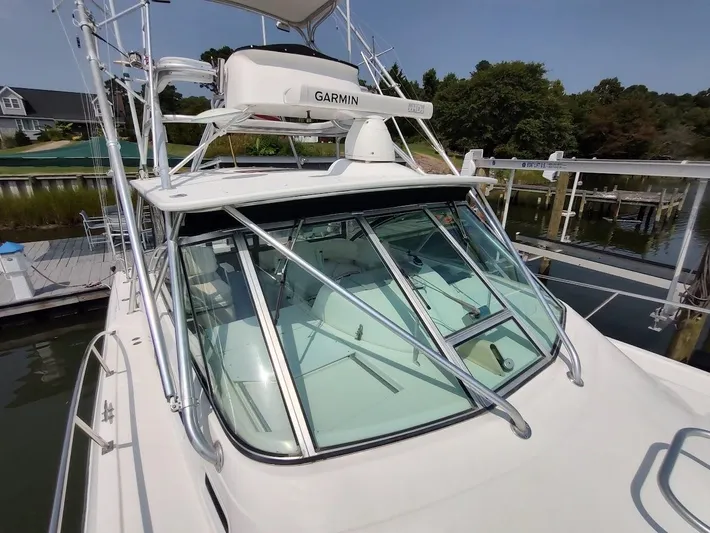 Reel Time Yacht Photos Pics 2005 Rampage 38 Express boat with Garmin equipment docked at a marina.