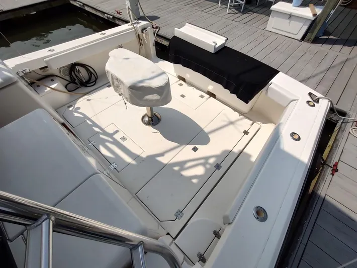 Reel Time Yacht Photos Pics 2005 Rampage 38 Express boat deck with covered seating and fishing equipment.