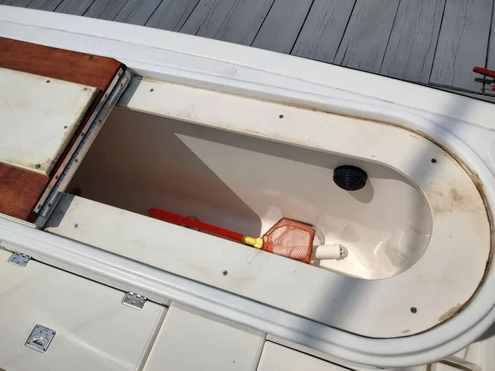 Reel Time Yacht Photos Pics Open storage compartment on 2005 Rampage 38 Express boat, showing interior and equipment.
