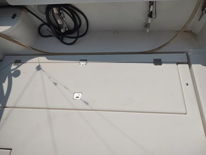 Reel Time Yacht Photos Pics 2005 Rampage 38 Express boat deck with storage compartment and coiled cables.