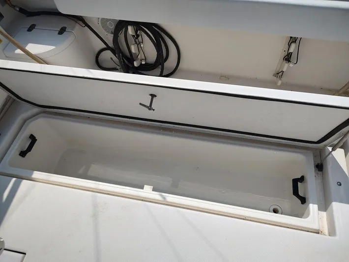 Reel Time Yacht Photos Pics Open storage compartment on 2005 Rampage 38 Express boat, showing interior space and handles.