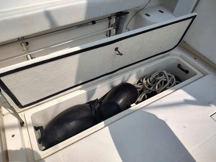 Reel Time Yacht Photos Pics Open storage compartment on 2005 Rampage 38 Express boat with ropes and fenders.