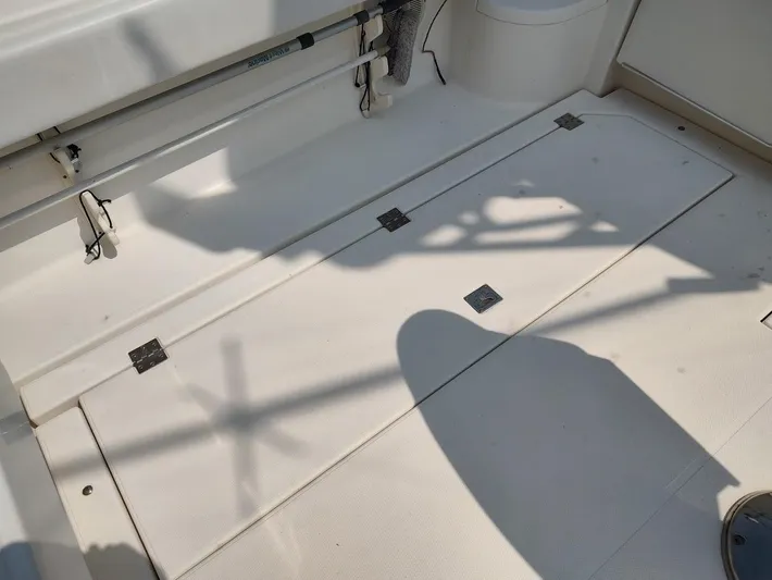 Reel Time Yacht Photos Pics 2005 Rampage 38 Express boat deck with storage compartments and fishing rod holders.