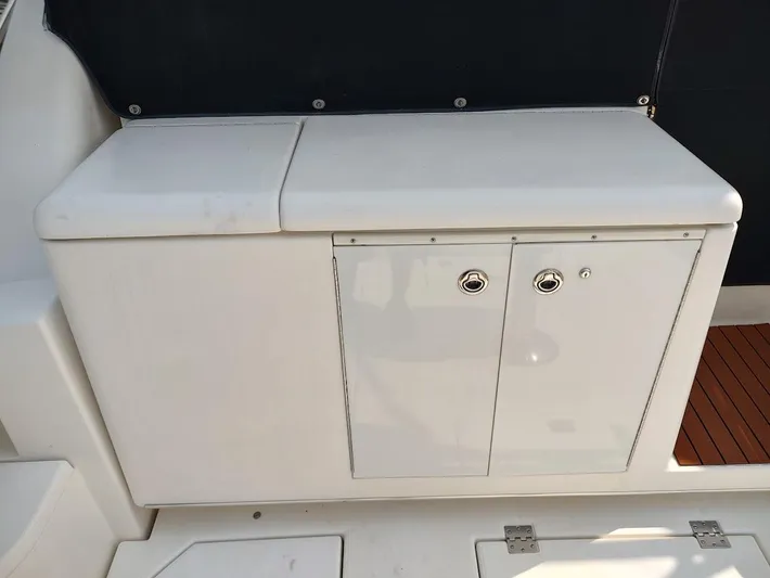 Reel Time Yacht Photos Pics 2005 Rampage 38 Express boat storage compartment with white cabinetry and sleek design.