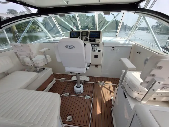 Reel Time Yacht Photos Pics 2005 Rampage 38 Express boat interior with helm, seating, and wood flooring.