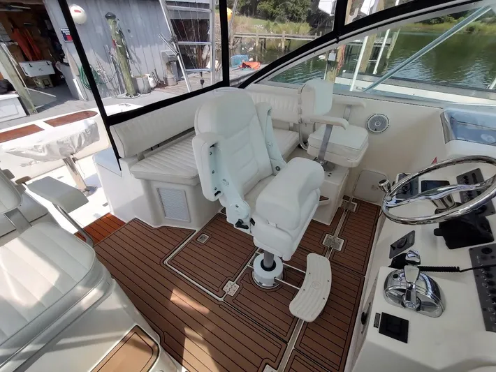 Reel Time Yacht Photos Pics 2005 Rampage 38 Express boat interior with white seating and wooden flooring.